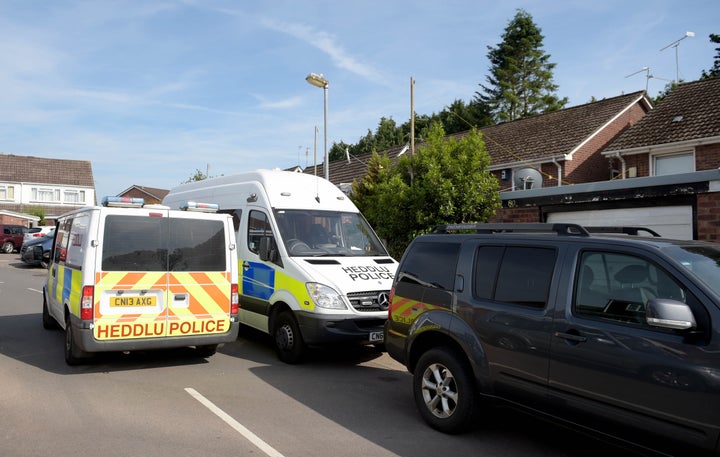 <strong>Police vehicles at the rear of a residence in Cardiff, as searches are being carried out in connection with the attack near to a Finsbury Park Mosque in north London</strong>