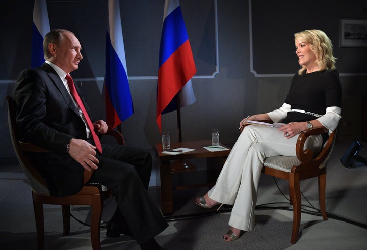 Russian President Vladimir Putin (L) speaks with journalist Megyn Kelly during an interview on the sidelines of the St. Petersburg International Economic Forum. 