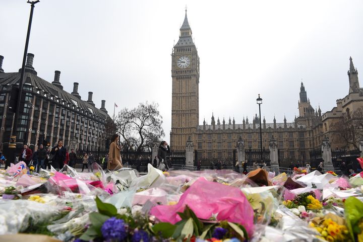 Flowers are left outside the Houses of Parliament in memory of those who died in the Westminster terror attack