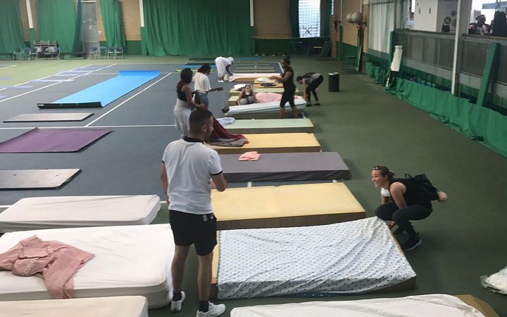 Beds are laid in the Westway Sports Centre shortly after the fire for those made homeless