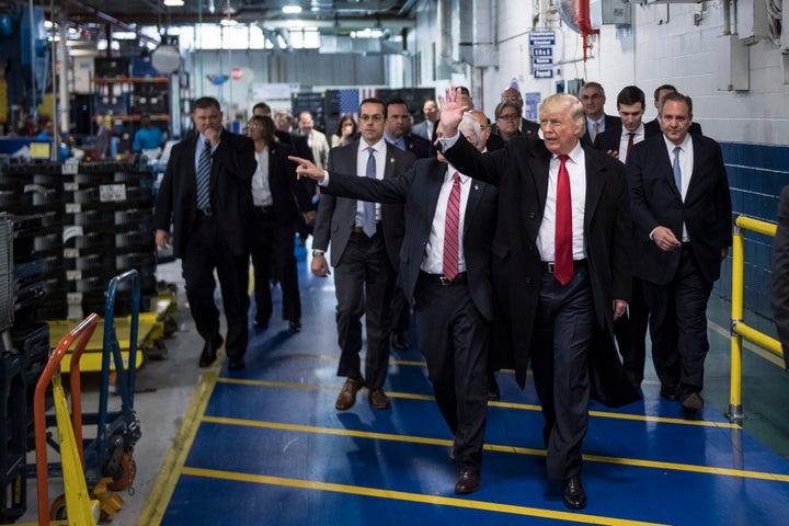 President Donald Trump and Vice President Mike Pence wave as they take a tour of Carrier Corporation in Indianapolis in December. 