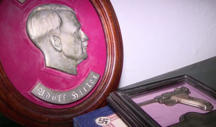 A shield featuring Adolf Hitler's profile was found, as were various weapons and instruments 