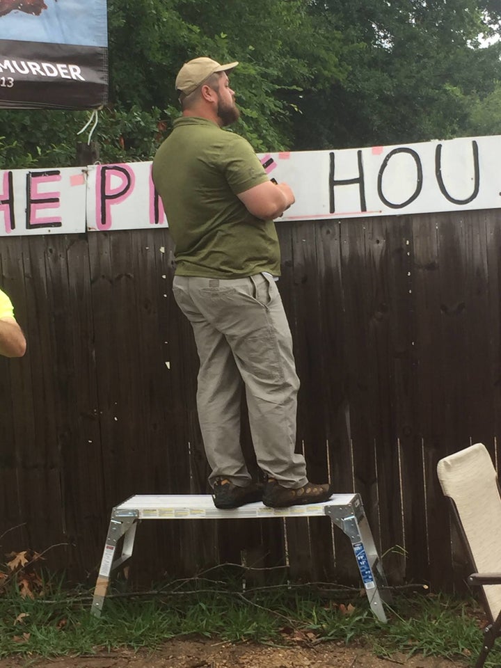 Keith Dalton, a member and organizer of anti-abortion group Abolish Human Abortion, stands on a step-ladder to see over the fence protecting the clinic in Jackson, Mississippi. The Jackson clinic is the only remaining abortion clinic in the entire state.