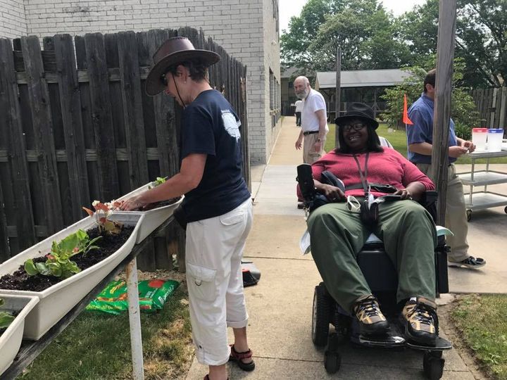 Some volunteer cyclists stopped in Cleveland, OH to plant flower boxes for MS resident, to beautify the space.