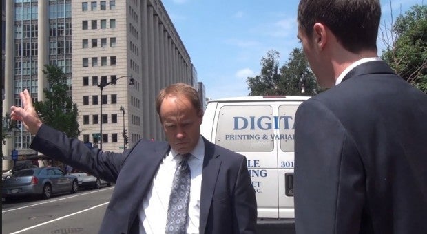 <p>Jeff Holmstead hails a cab during an impromptu political debate.</p>