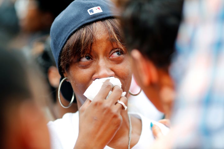 Diamond Reyonlds, the girlfriend of Philando Castile who was in the car with her then 4-year-old daughter, is comforted at a St. Paul, Minnesota, rally on July 7, 2016.