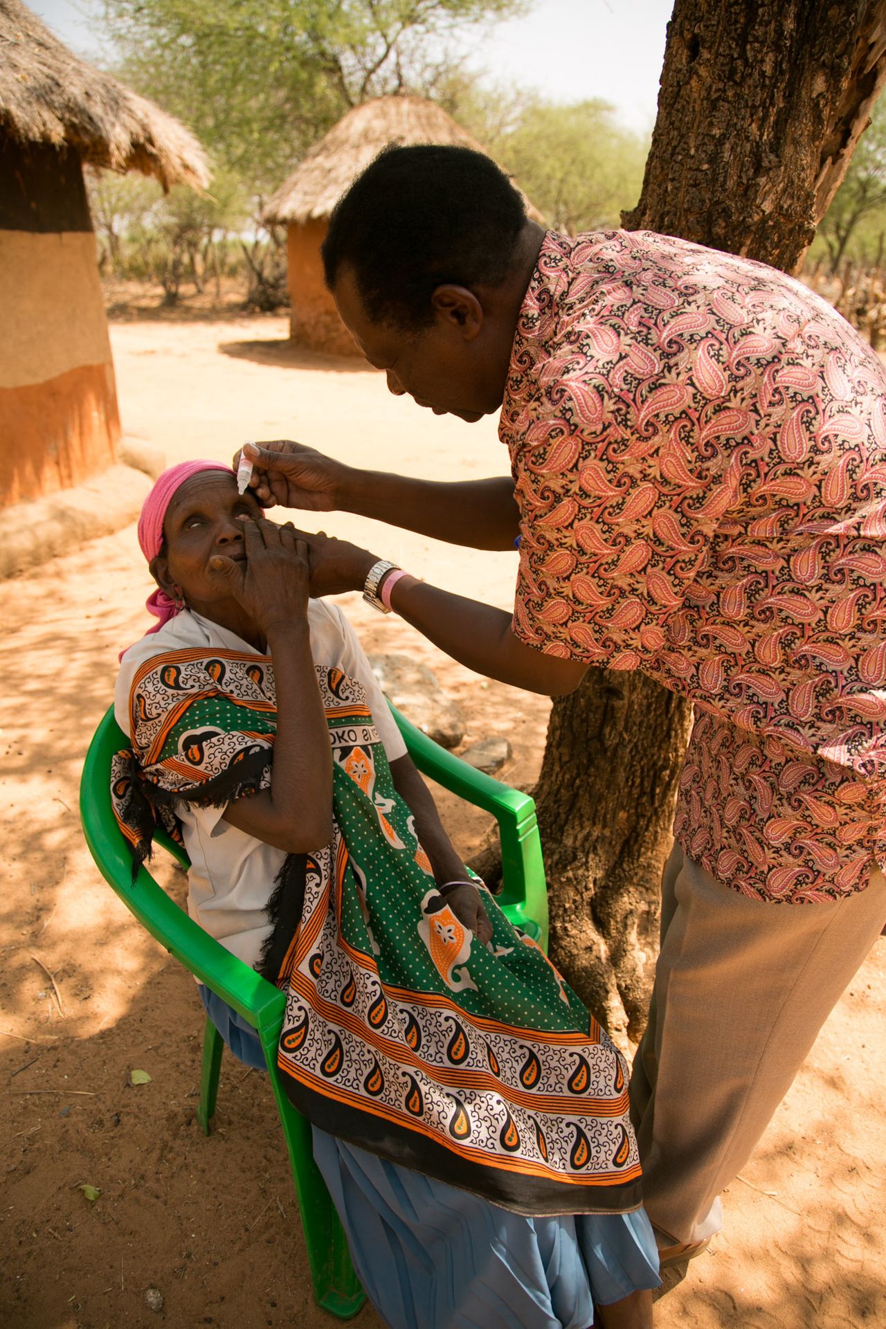 Dr. Michael Makari applies eyedrops to Chepserum’s eyes during a follow-up visit. Makari has performed basic surgeries on trachoma sufferers in this remote area of Kenya, helping people like Chepserum to see again.