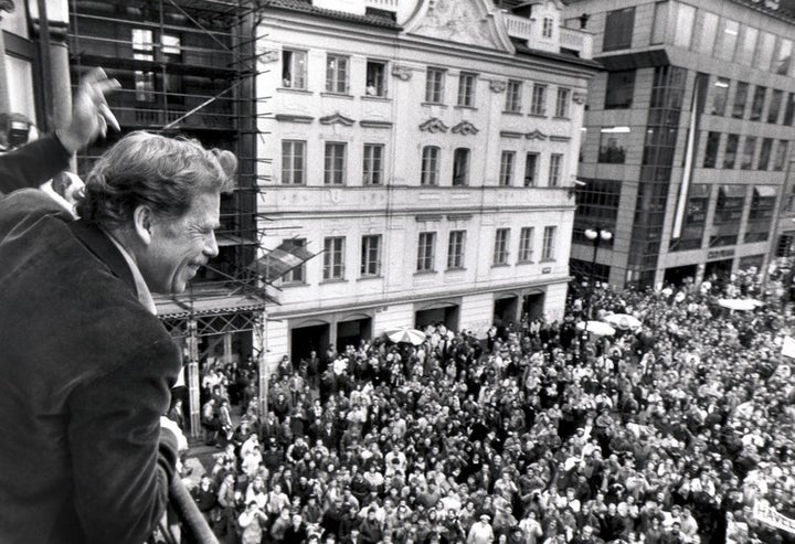 Presidential candidate Vaclav Havel waving to his supporters from a balcony in Prague on December 19 1989.