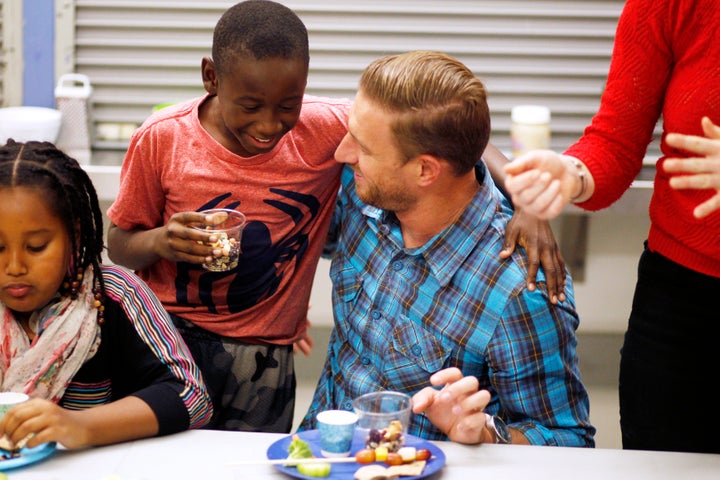 Ryan Graves eats with fourth grader Frederick Dozier during Cooking Matters, a nutrition class at Glen Park Elementary School in San Francisco.