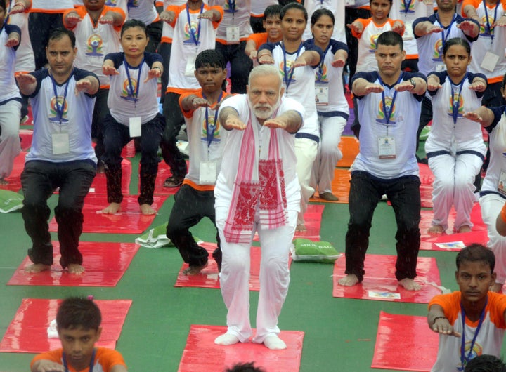 Enthusiasts braving the rain at Ramabai Ambedkar Park on the International Yoga Day being attended by PM Narendra Modi. 