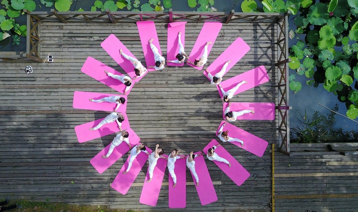 Yoga fans practise yoga during an event marking the International Yoga Day in Yangzhou, east China's Jiangsu Province.