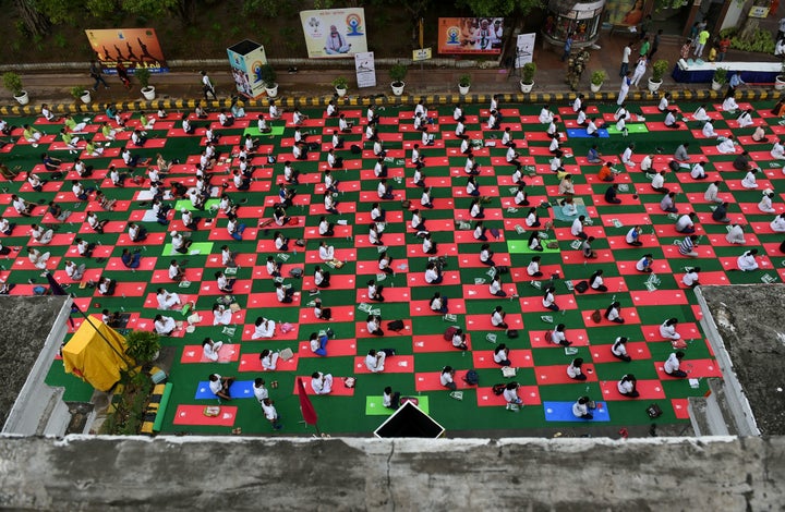 Indian yoga practitioners participate in a mass yoga session on International Yoga Day in New Delhi.