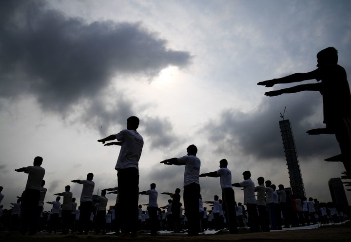 Members of India's National Cadet Corps (NCC) take part in a mass yoga session to mark International Yoga Day on The Brigade