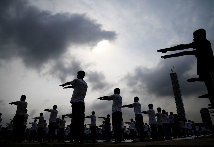 Members of India's National Cadet Corps (NCC) take part in a mass yoga session to mark International Yoga Day on The Brigade Parade Grounds in Kolkata.