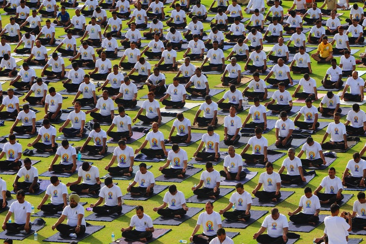 Yoga enthusiasts take part in a yoga session during the 3rd International Yoga Day at SMS stadium in Jaipur, Rajasthan, India. 