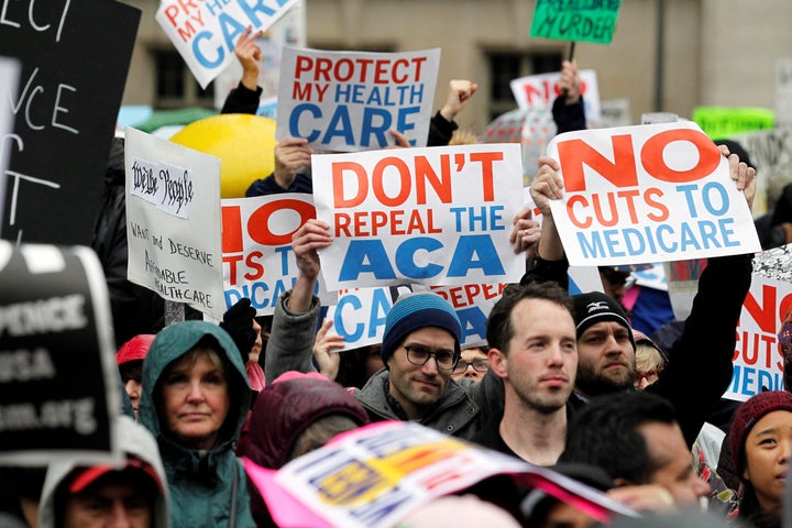 Demonstrators hold signs in support of Obamacare near a Philadelphia hotel where Republican lawmakers were attending a retreat in January. 