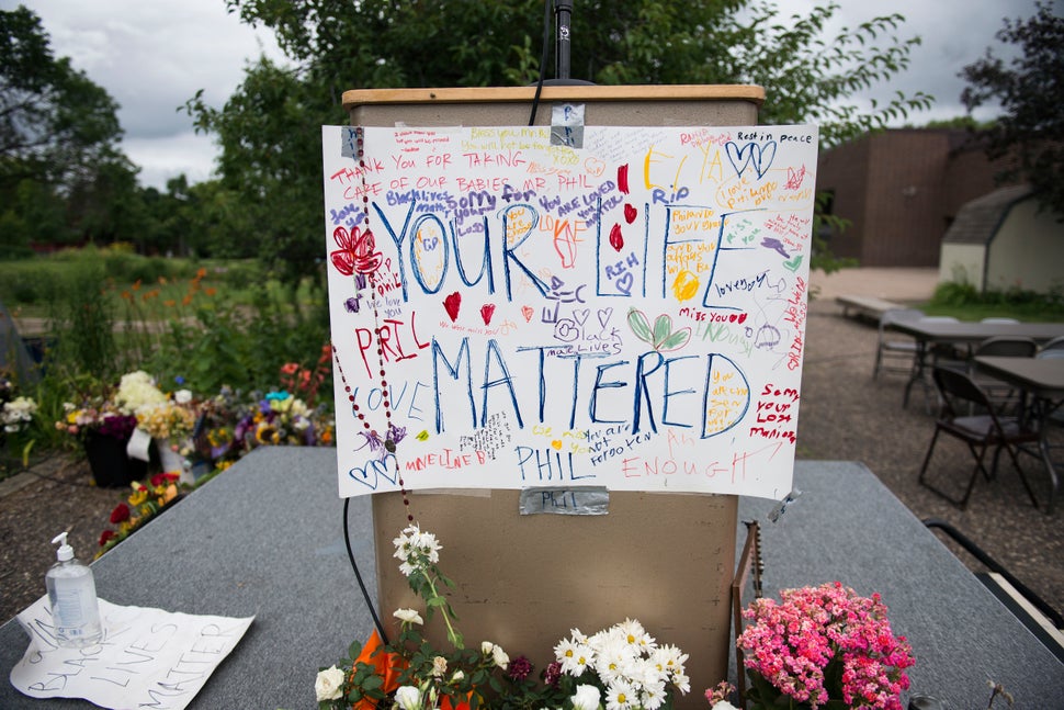 A sign reading "Your Life Mattered" hangs on a podium outside J.J. Hill Montessori School on July 14, 2016, in Saint Paul, Mi