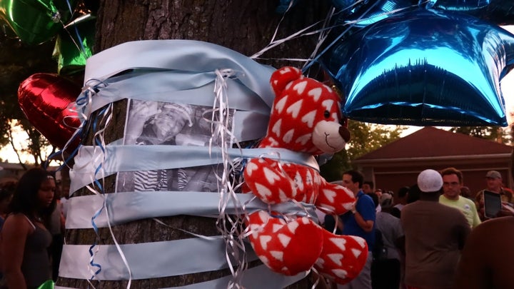 A teddy bear is seen on a tree during a commemoration ceremony held for Sylville Smith, who was shot and killed by a police officer in Milwaukee last year.