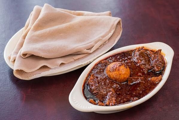 Doro Wot : Chicken stew with garlic onion and herbal butter served with boiled egg.