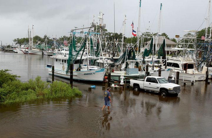 Kenny Kuluz wades through flood waters at the Ocean Springs harbor as Tropical Storm Cindy dumped rain on the Mississippi Gulf Coast on Wednesday.