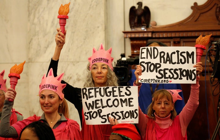 Protesters with Code Pink hold signs at the Senate Judiciary Committee confirmation hearing for Sen. Jeff Sessions (R-Ala.) to become U.S. attorney general on Jan. 10.