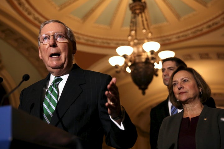 Senate Majority Leader Mitch McConnell speaks as Sen. Shelley Moor Capito (R-W.Va.) listens in the background.