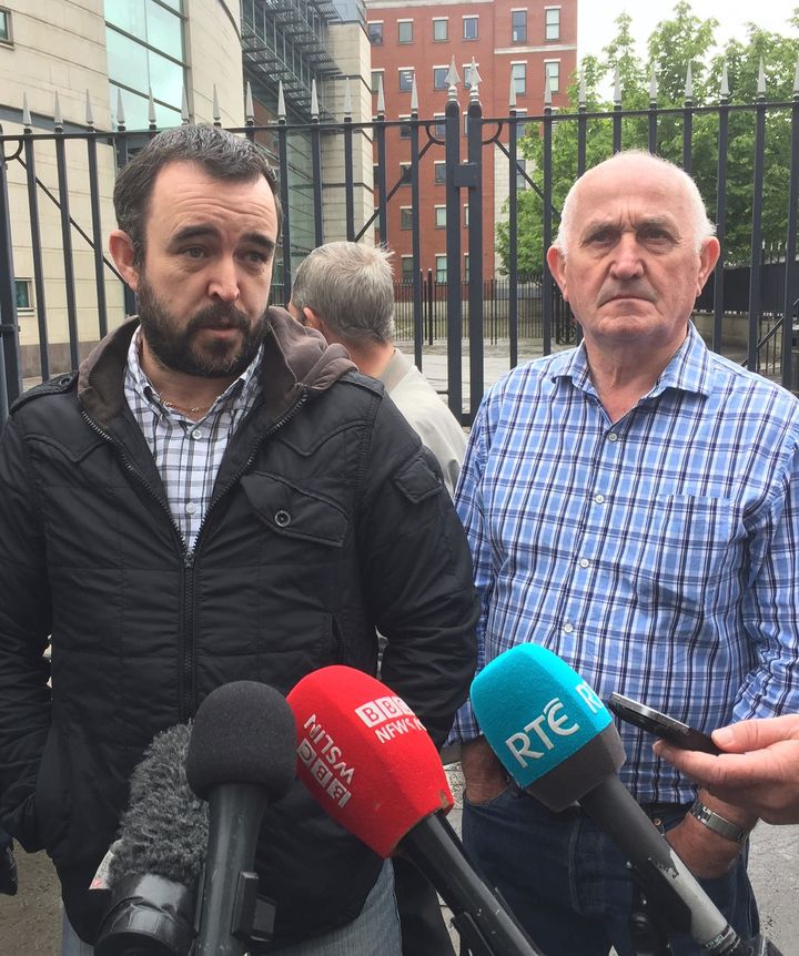 Ciaran, the son of murder victim Eamon Fox (L) and Joe, the father of victim Gary Convie, outside the Belfast Crown Court on Friday 