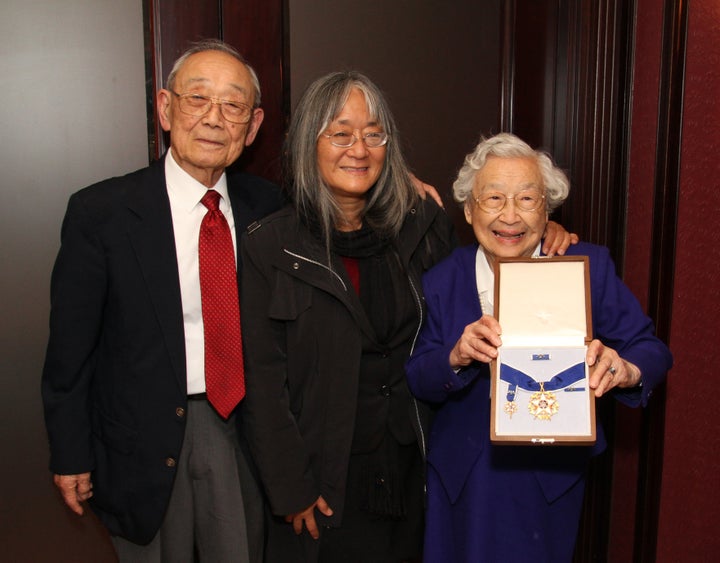 Homer Yasui, left, and Yuka Yasui Fujikura, right, Minoru Yasui's surviving siblings, with Min's daughter Holly Yasui, center. Yuka is holding the Presidential Medal of Freedom, posthumously awarded to Minoru.