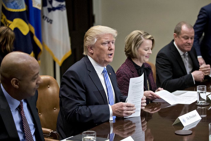 President Donald Trump at a listening session with CEOs from the retail industry in February. Seated from left to right are M
