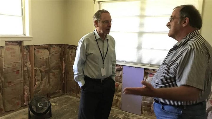 <p>Chris Andrews (left), executive director of Rebuilding Together Baton Rouge, talks to a volunteer as they prepare to repair drywall in a Baton Rouge home that was flooded last August.</p>