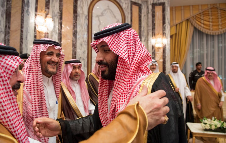 Saudi Arabia's Crown Prince Mohammed bin Salman (R) speaks with members of the royal family during an allegiance pledging cer
