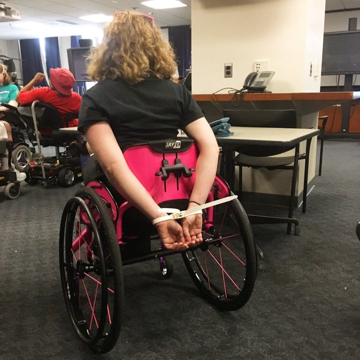 Stephanie Woodward, handcuffed after the protest.