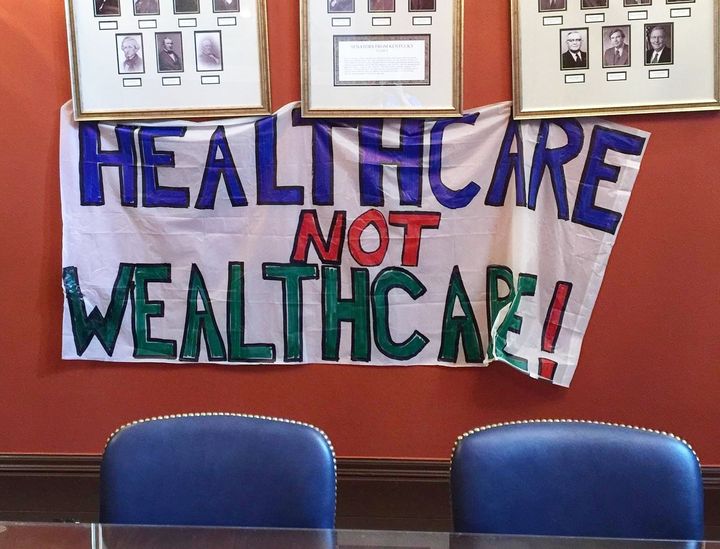 Protester Stephanie Woodward took this photo of a banner protesters hung in the office of Senate Majority Leader Mitch McConnell.