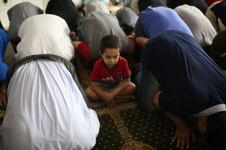 A child sits during a prayer on Laylat al-Qadr on the 27th day of the fasting month of Ramadan in New Jersey, United States o
