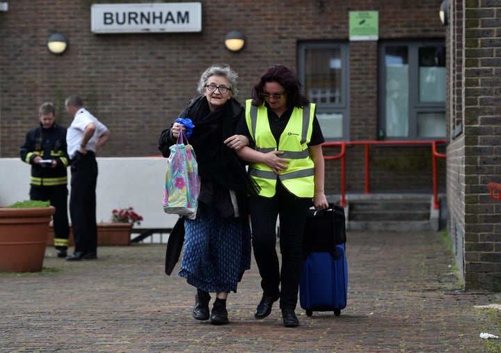 A resident is evacuated from the Burnham Tower residential block following concerns over the type of cladding used on the outside of the building on the Chalcots Estate in north London