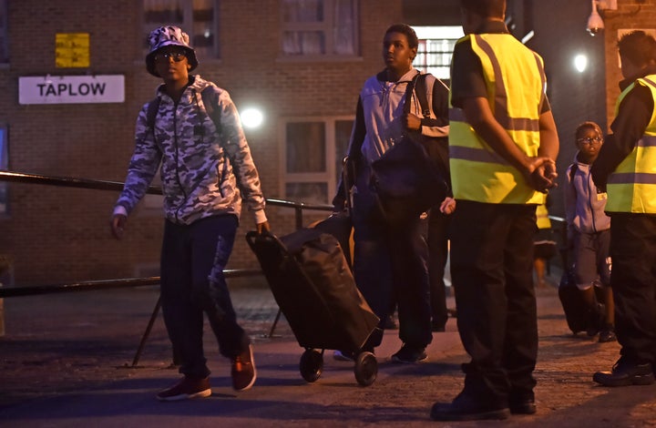 Residents are seen leaving Taplow Tower on Friday night