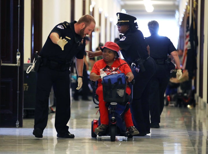 U.S. Capitol Police remove protesters from in front of the office of Senate Majority Leader Mitch McConnell on June 22, 2017.