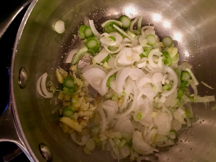 <p>New-season onions and chopped ginger start the dish</p>