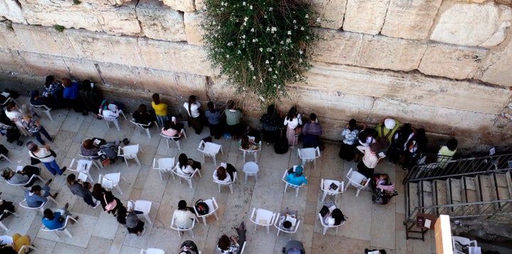 Jewish women pray at the women's section of the Western Wall.