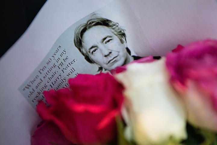 Floral tributes to British actor Alan Rickman are seen at the Platform 9 3/4 Harry Potter display at King's Cross station in London.