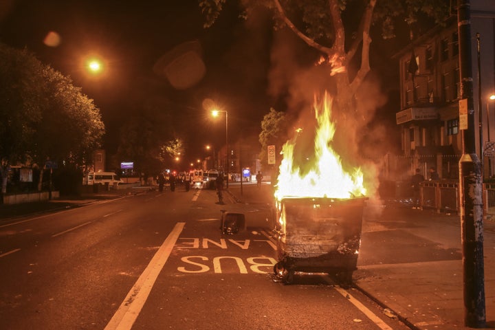 A bin burns near Forest Gate police station on Sunday evening