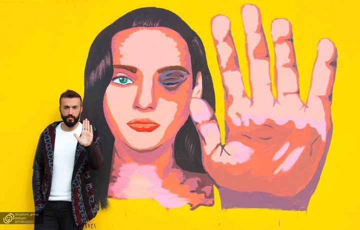 <p>Kurdish LGBT activist Ayaz Shalal with one of his organization’s public art projects for gender equality, in Sulaimaniya, Iraqi Kurdistan.</p>