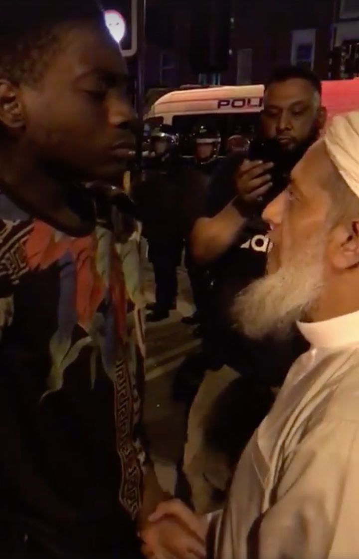 The clip shows the elderly Muslim man soothing the younger man with a hug during the protests on Sunday evening 