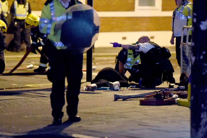 <strong>Police officers help a person on Romford Road in Forest Gate</strong>