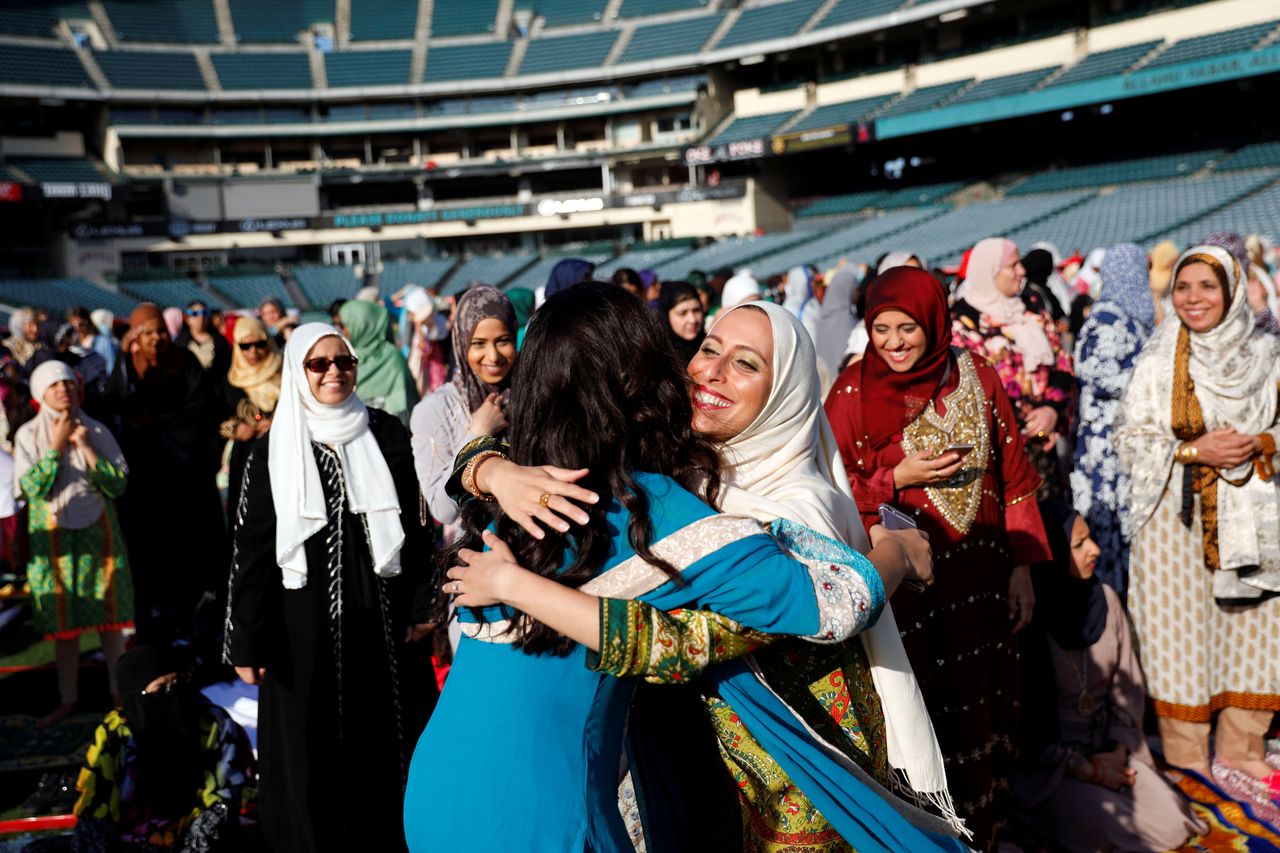 Muslim women hug as they gather for the celebration of the Eid al-Fitr holiday, the end of the holy month of Ramadan at Angel Stadium of Anaheim in Anaheim, California, U.S., June 25, 2017.