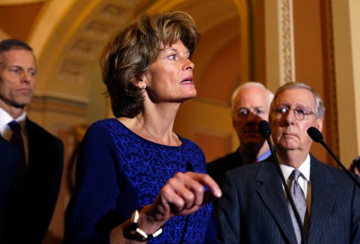 U.S. Senate Majority Leader Mitch McConnell (R-KY) (R) listens to Sen. Lisa Murkowski (R-AL) as she speaks to the media, January 27, 2015.