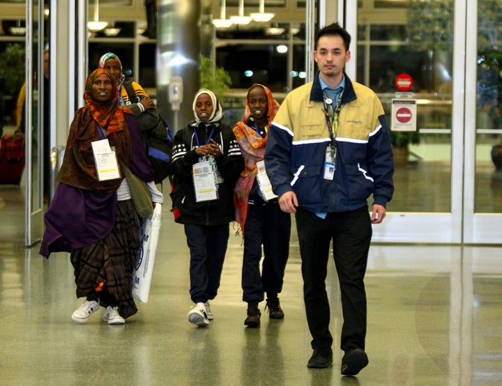 Safiya Hassan, Dahaba Matan, Farduwsa Matan, and Nima Matan, refugees from Somalia, are escorted by a United Airlines representative before being met by their U.S.-based family members on arrival at the airport in Boise, Idaho, U.S. March 10, 2017.