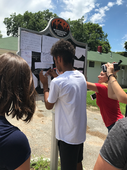 Josh Hagene, another Cultural Leadership teen, adds Till’s history back to his marker.