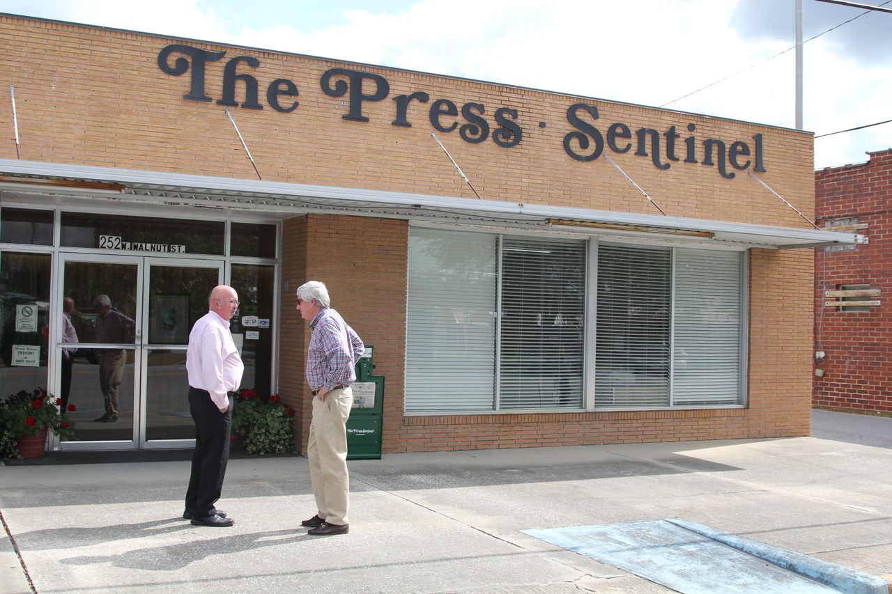W.H. "Dink" NeSmith (right) talks to a Wayne County resident outside the offices of the Press-Sentinel, a newspaper he has owned for more than 30 years. 
