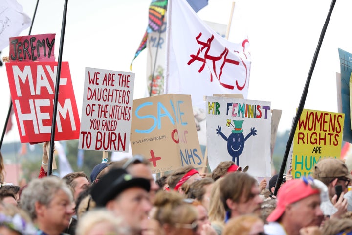 Crowds hold signs as they are excited by Jeremy Corbyn as he speaks on the Pyramid stage at Glastonbury Festival last week